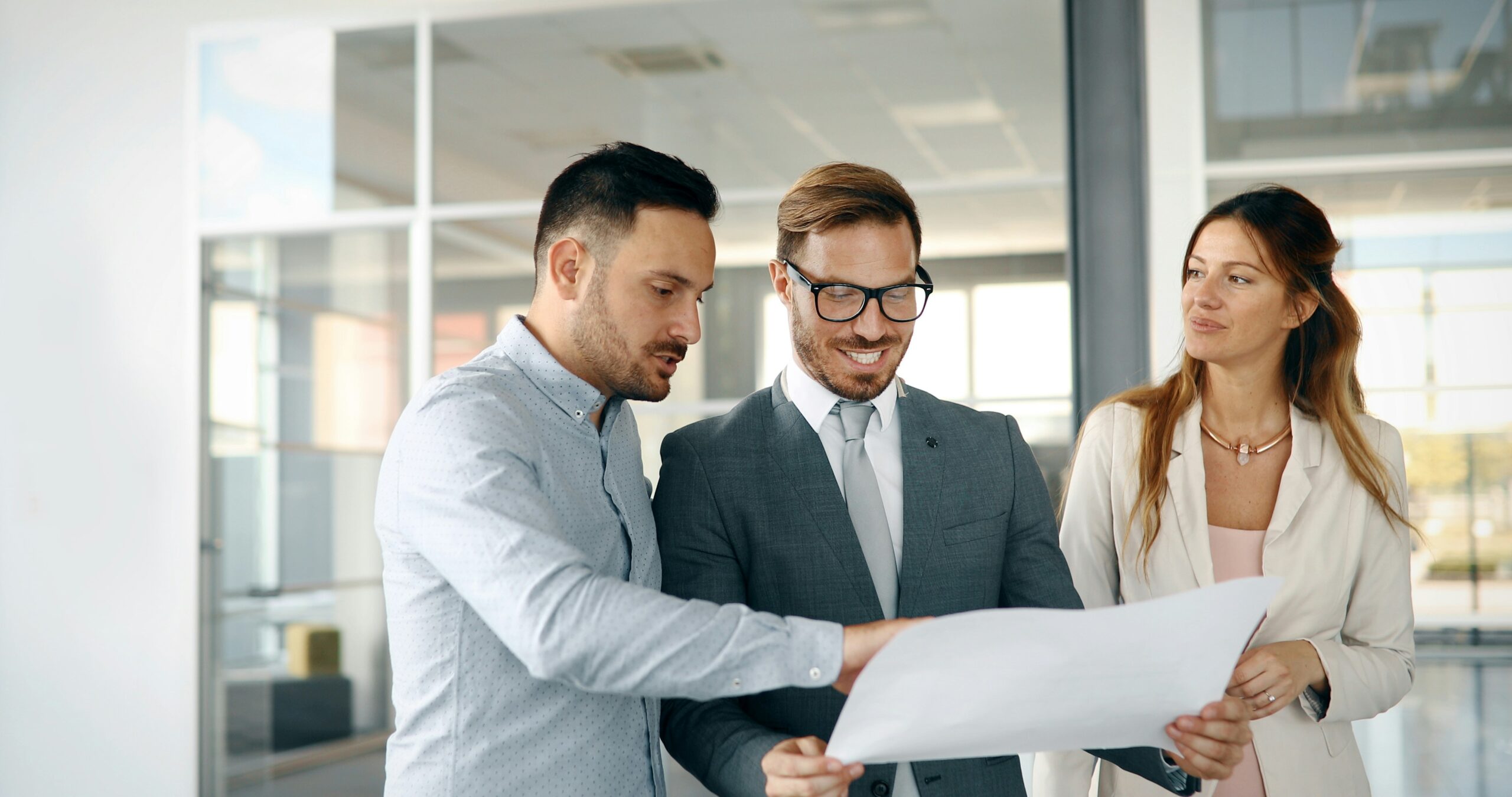 Professionals reviewing work outcomes in a corporate setting, symbolizing how expertise, reputation, and visibility shape value exchange, recognition, and career progression for mid-career professionals.